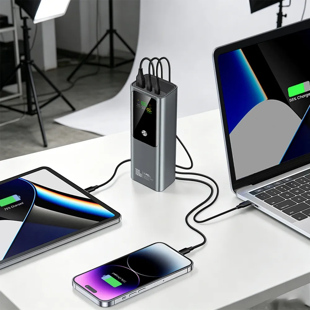 100W Laptop Power Bank charging laptop, tablet and phone at a work desk